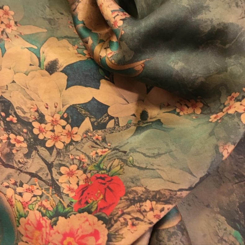 Skilled artisans hand-dyeing gambiered silk (Xiangyunsha) using ancient techniques in Guangdong. Explore our heritage craftsmanship in the About Us section.