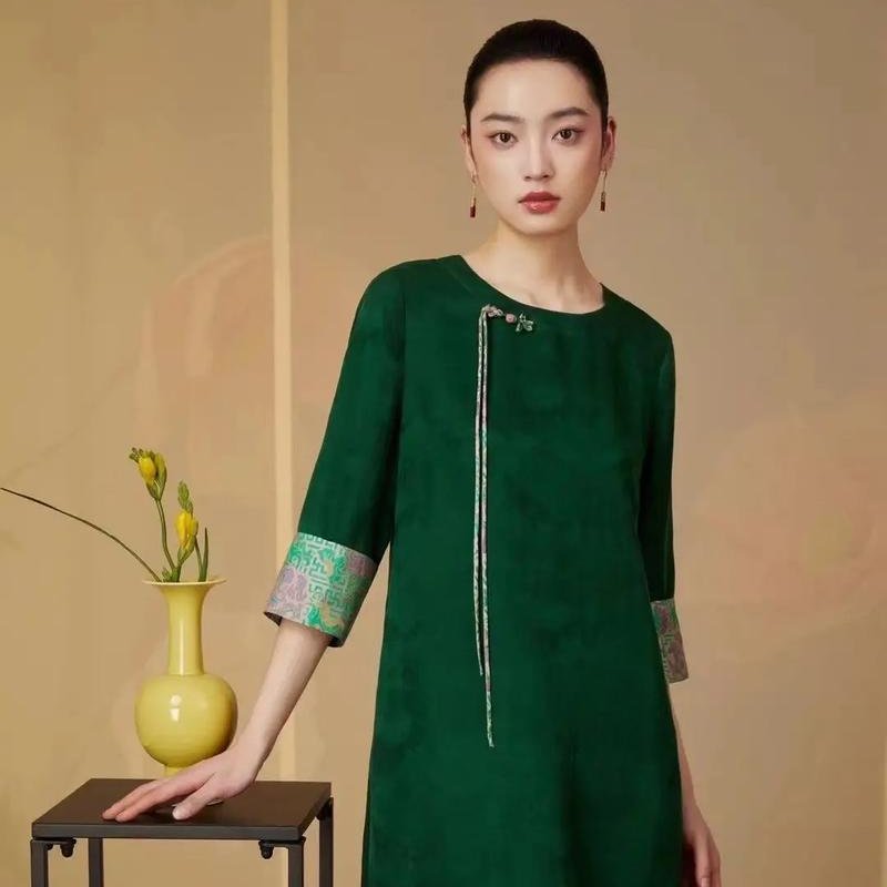 Model wearing an elegant Xiangyunsha Silk cheongsam, showcasing timeless Chinese style.