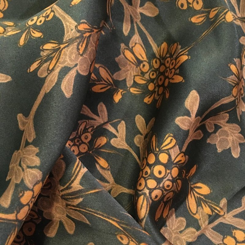 Close-up of Xiangyunsha Silk fabric highlighting its unique texture and sheen.